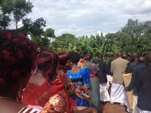 Lining up to go inside.  Don't you love Ugandan hairstyles?